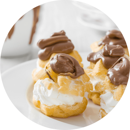 profiteroles with vanilla filling and chocolate on top